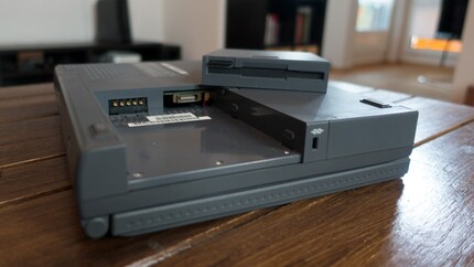 I find screws underneath the floppy disk drive.
