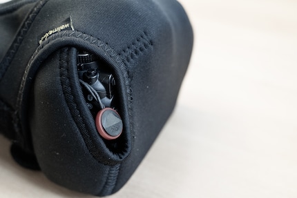 The hole is practical for the carrying straps, but reduces the protection.