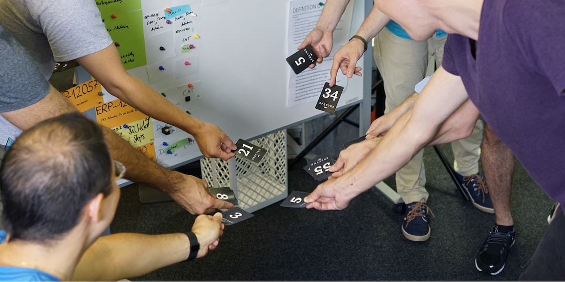 Playing planning poker to estimate the amount of work required with the numbers of the Fibonacci sequence.