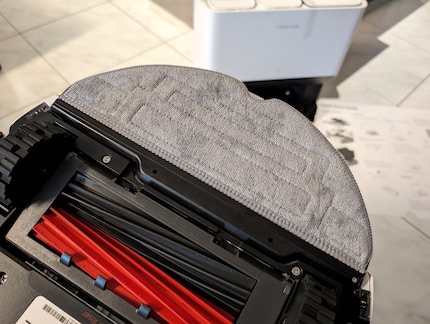 The Roborock has a large-surface mop that vibrates.