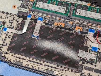 The touchpad screws are no longer hidden under the mainboard.