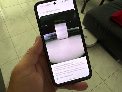 Is that a cup with a sofa standing on it?