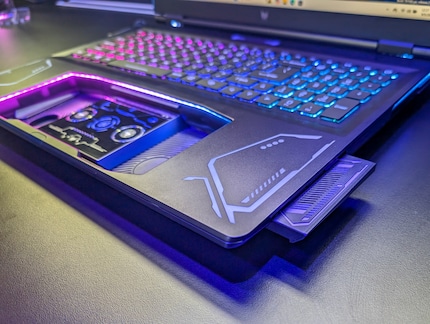 The extendable speakers are located to the side of the touchpad.