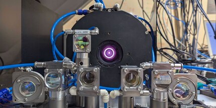 The laser is in the centre of the image; lenses and mirrors mounted in front of it reflect the laser beam and redirect it.