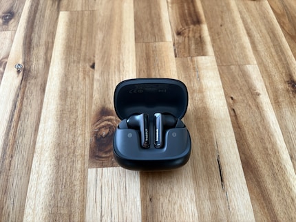 The earbuds are pulled into the case via magnets.