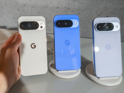 The Pixel 10 Pro on the left compared to the Pixel 10 in the centre and on the right. The white colour is also different.
